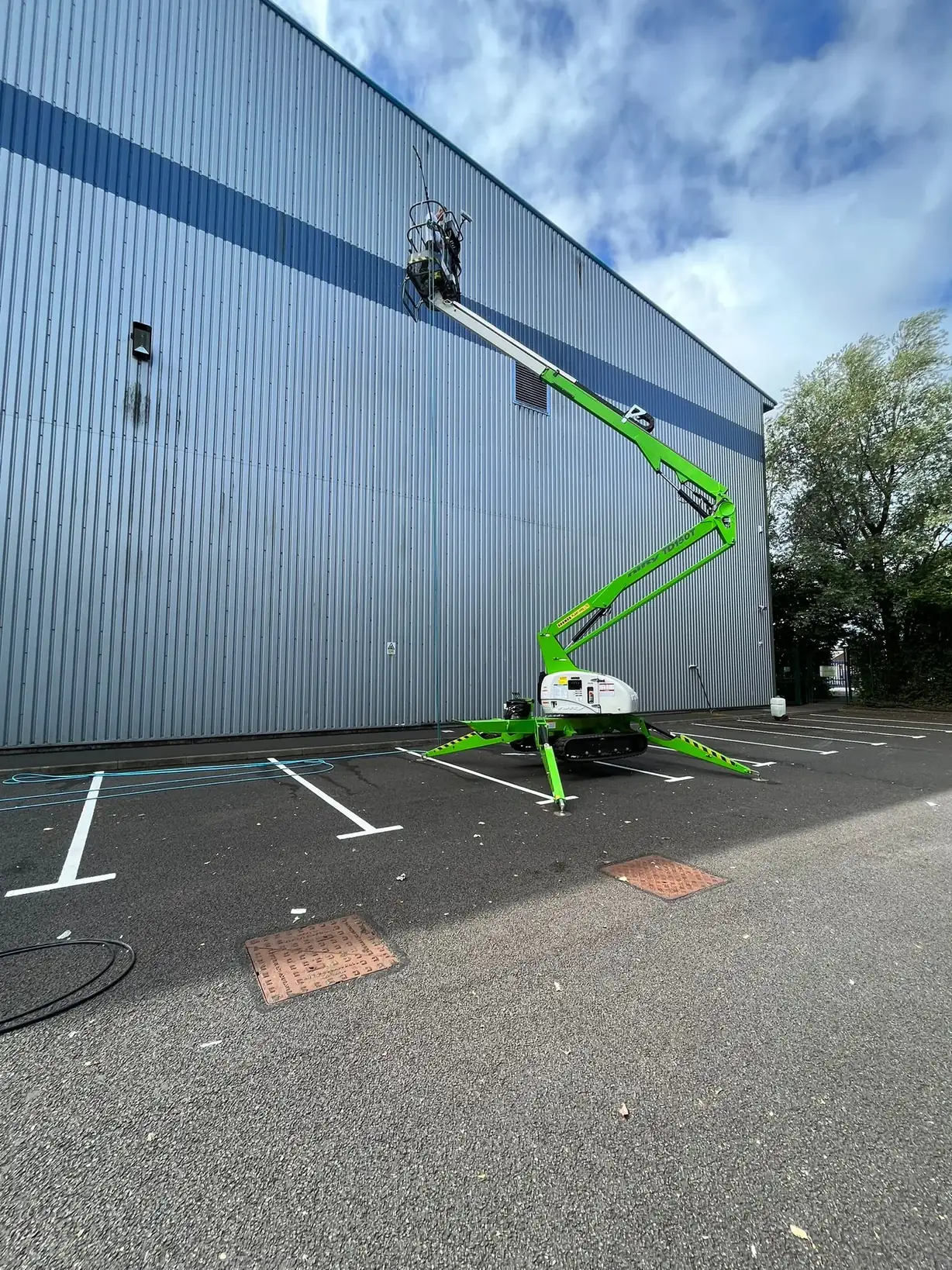 Industrial cladding cleaning with soft-wash system