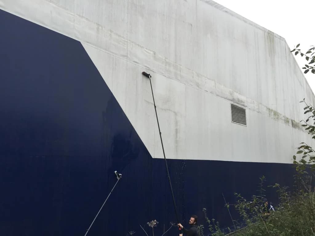 Water fed pole cleaning navy and white painted cladding panels